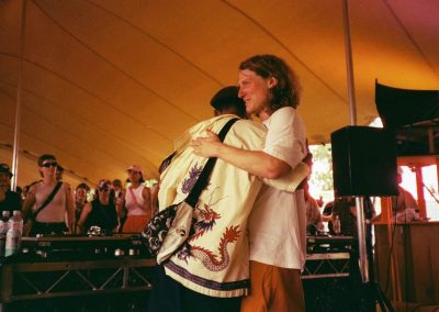 men hugging inside the tent